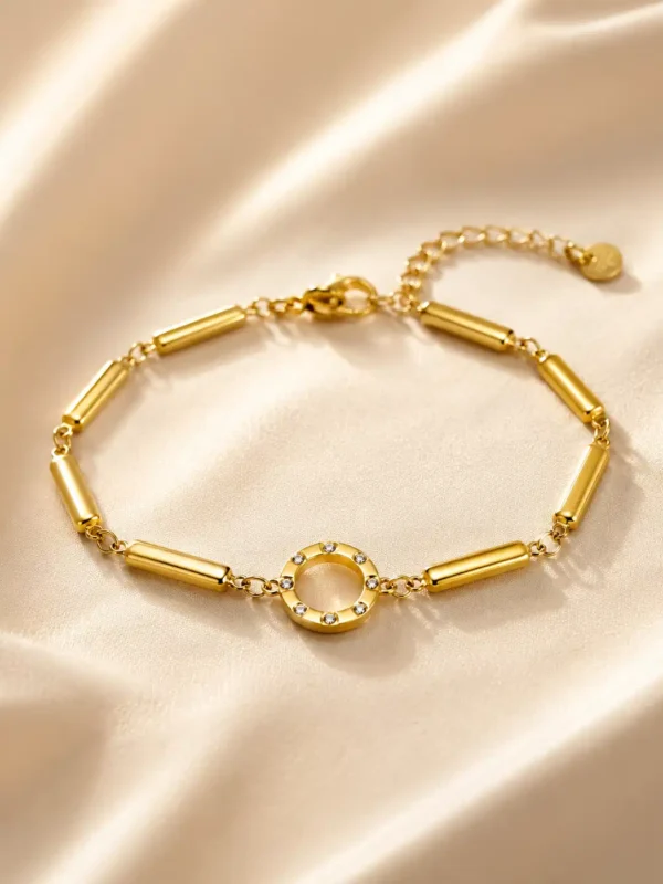 Anti-tarnish gold-plated link bracelet with crystal halo centre displayed on champagne satin