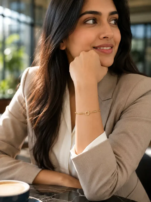 Woman wearing Aurelia anti-tarnish gold link bracelet with crystal halo centre for an office wear look