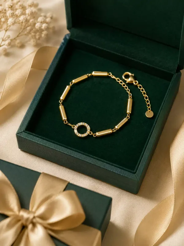Gold-plated Aurelia Halo Link Bracelet with crystal centre displayed in dark green jewellery box