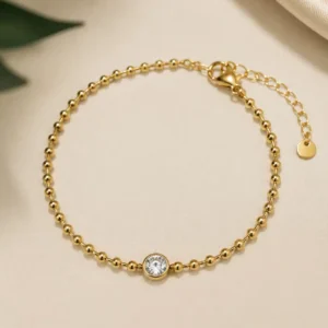 Elara anti-tarnish gold beaded bracelet with bezel-set solitaire stone for women