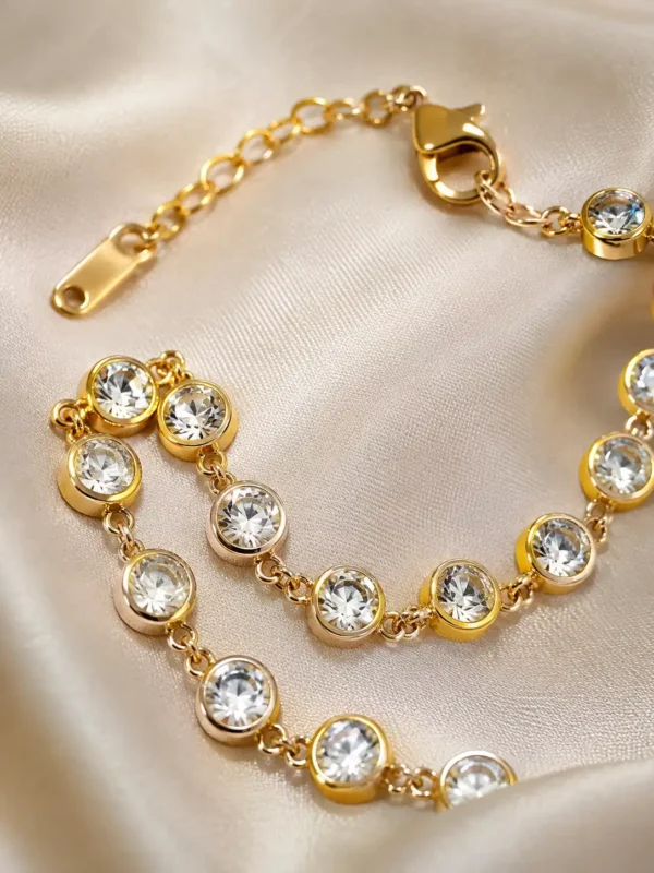 Close-up of round cubic zirconia stones in gold bezel settings on Elara tennis bracelet