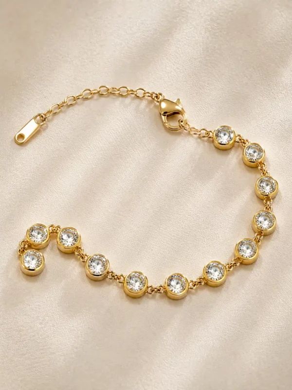 Full Elara CZ tennis bracelet showing gold bezel stones, lobster clasp and extension chain