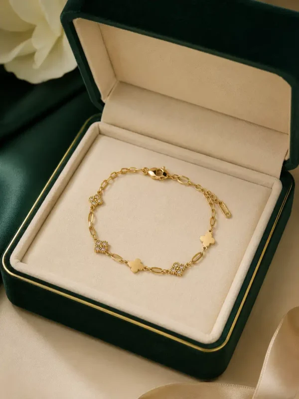 Elara crystal clover gold bracelet displayed in green jewellery box