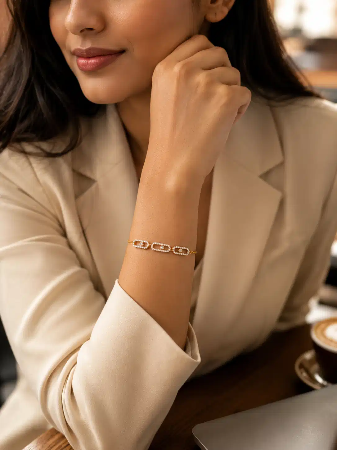 Woman wearing Aurelia anti-tarnish crystal link bracelet with neutral workwear