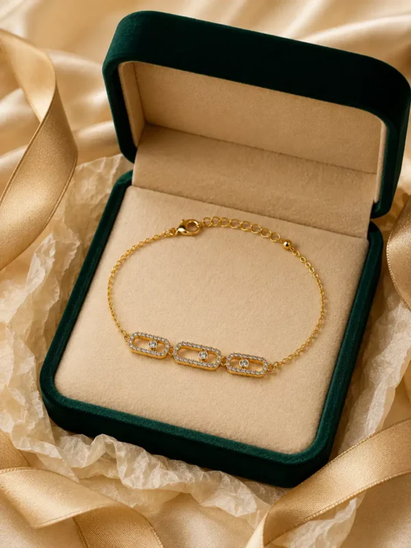 Anti-tarnish gold-tone crystal link bracelet displayed in green gift box with satin styling