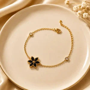 Noir Bloom anti-tarnish gold-plated bracelet with black floral charm and crystal accents