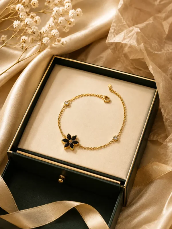 Anti-tarnish gold-plated black flower bracelet displayed in premium jewellery gift presentation