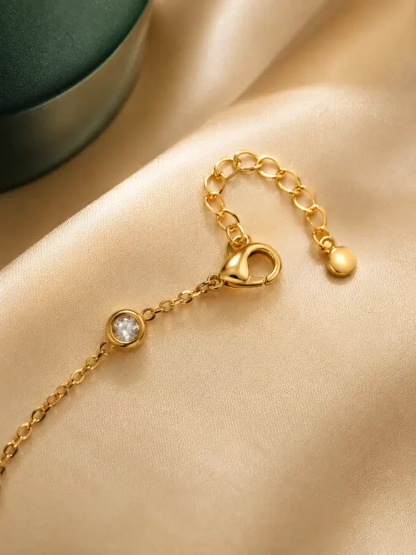 Close-up of lobster clasp, 4 cm extension chain and crystal station on Noir Bloom gold-plated bracelet