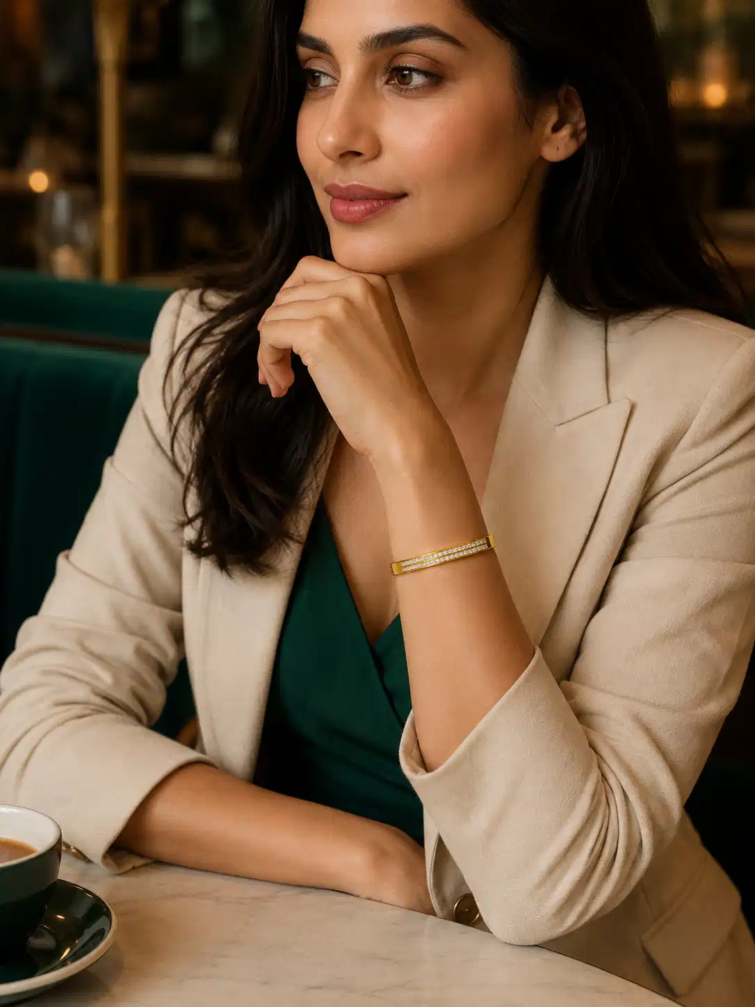 Woman wearing a double-row gold CZ bangle with a blazer for polished office styling