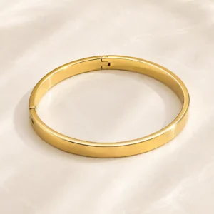 Anti-tarnish sleek gold bangle for women with polished flat profile and hinged closure