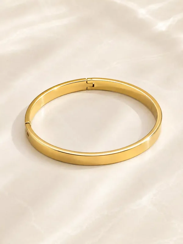 Anti-tarnish sleek gold bangle for women with polished flat profile and hinged closure