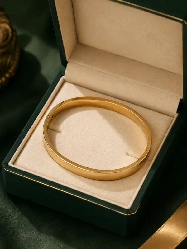 Minimal gold bangle displayed inside premium green jewellery box by Purnave Jewelz