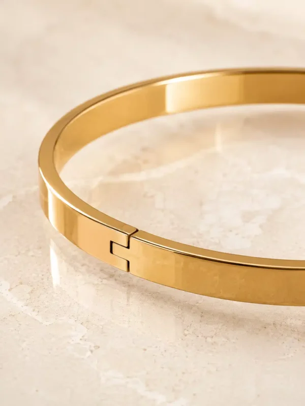 Close-up of hinged closure on anti-tarnish gold bangle bracelet for women