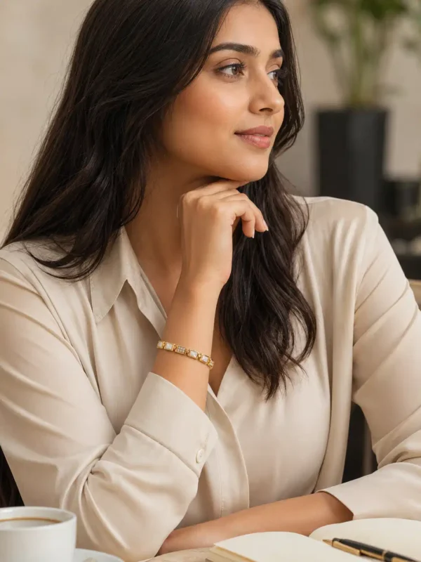 Woman wearing Ivory Glow gold link bracelet with white and crystal accents for an office wear look