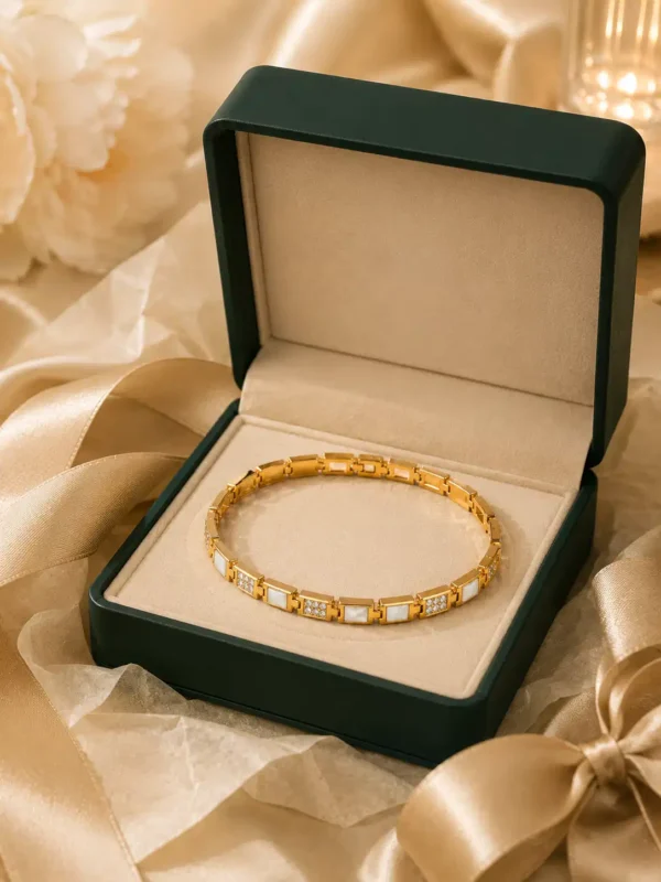 Gold and white crystal link bracelet presented in a green gift box with satin ribbon styling