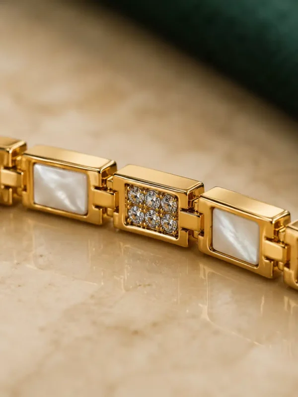 Close-up of white inlay and crystal pavé links on the Ivory Glow gold bracelet