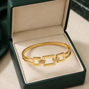 Anti-tarnish gold geometric bangle with rectangular links and crystal accents in jewellery box
