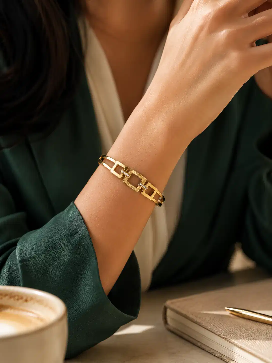 Woman wearing anti-tarnish geometric gold bangle with crystal accents for office wear