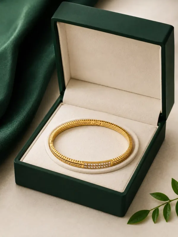 Anti-tarnish gold crystal bangle displayed in green jewellery box