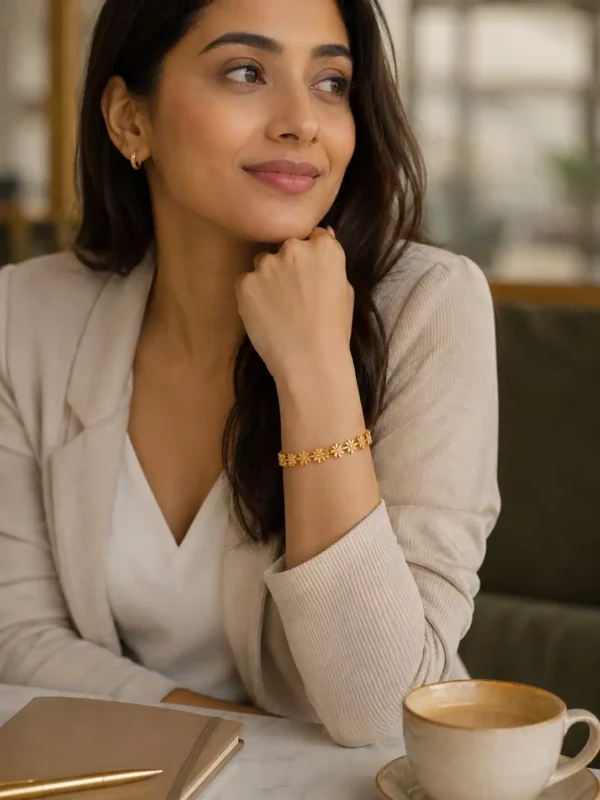 Woman wearing Daisy Glow floral gold bangle with beige office outfit