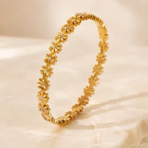 Daisy Glow anti-tarnish gold floral bangle with daisy motifs and sparkling stone centres