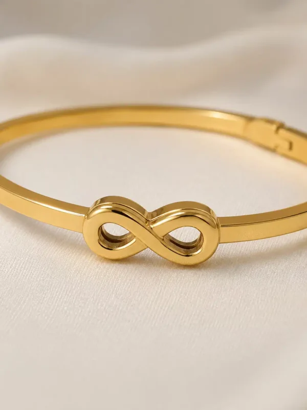 Close-up of polished infinity motif on gold-toned anti-tarnish bracelet