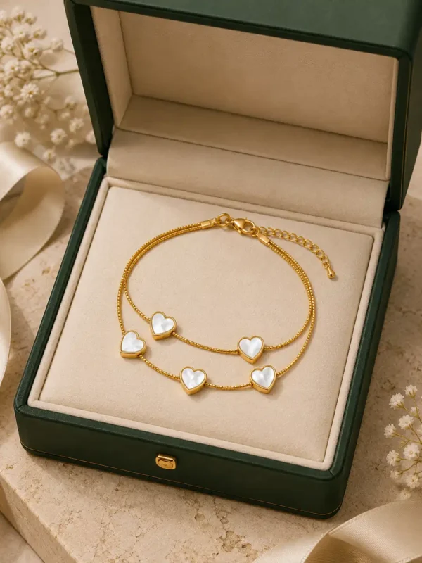 Pearl Essence gold heart bracelet displayed in jewellery box