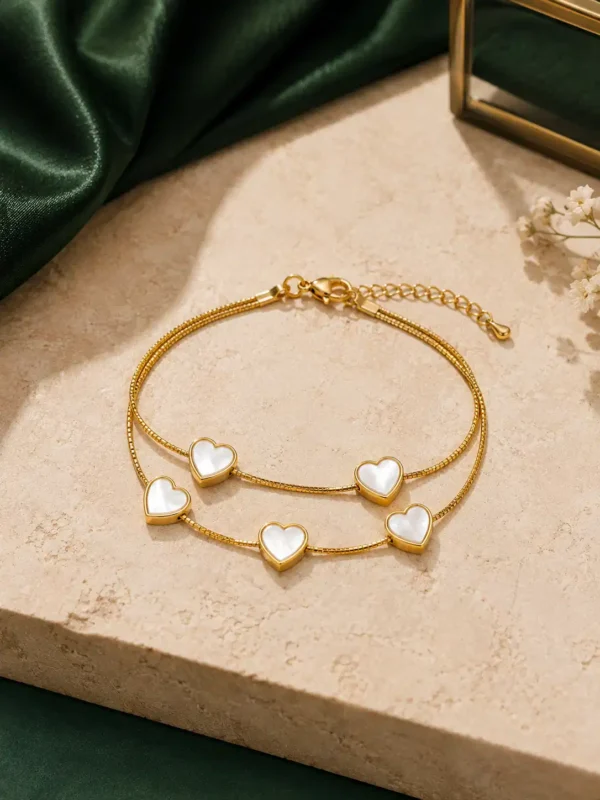 Adjustable gold double-strand heart bracelet with lobster clasp and extension chain