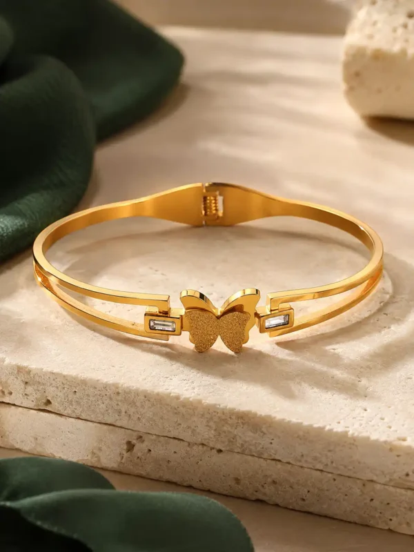 Gold-plated stainless steel butterfly bangle with double-band design and crystal details