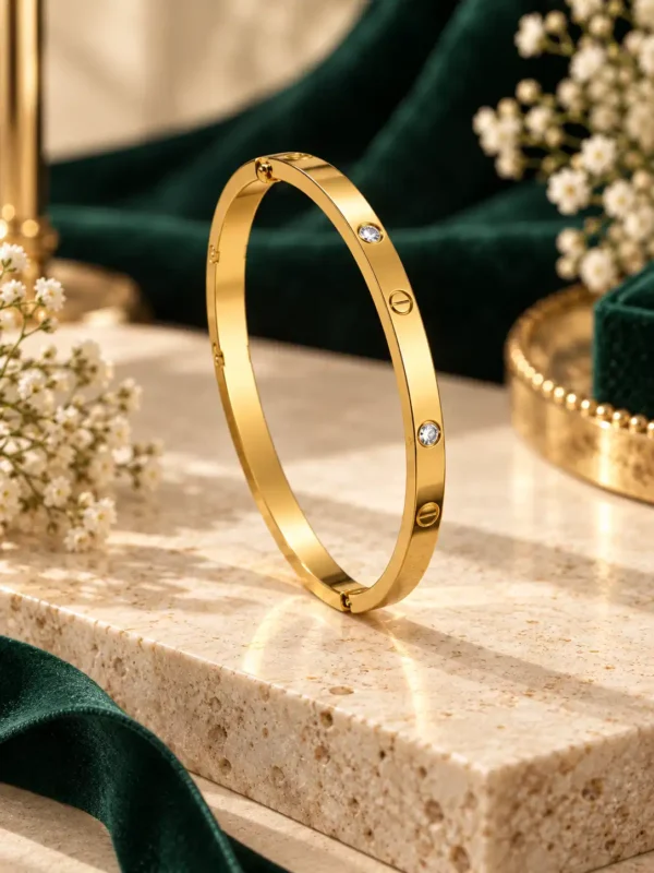 Gold-toned anti-tarnish screw bangle with crystal accents in angled view
