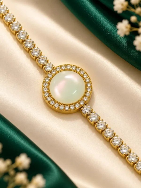 Close-up of mother-of-pearl centre and cubic zirconia stones on gold tennis bracelet