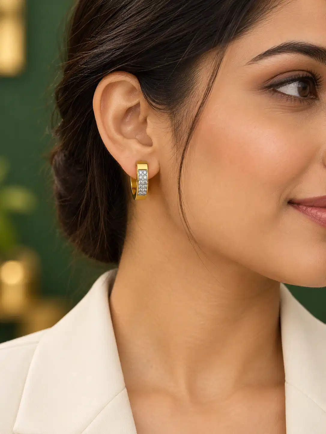 Woman wearing 2 cm gold crystal huggie hoop earrings for office wear