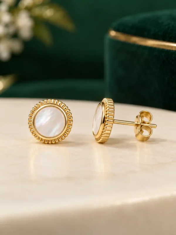 Mother-of-pearl stud earrings showing gold fluted bezel, post and push-back closure