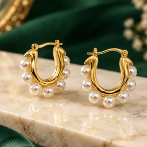 Anti-tarnish gold pearl hoop earrings with white pearl accents in a curved U-shaped design