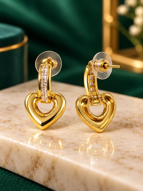 Gold crystal heart drop earrings showing front and post closure