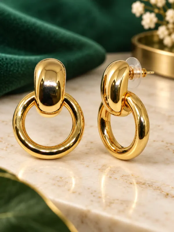 Gold crystal heart drop earrings showing front and post closure