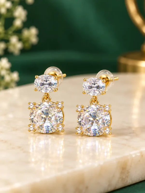 Gold-plated double crystal drop earrings with oval top stones and larger clear round crystals