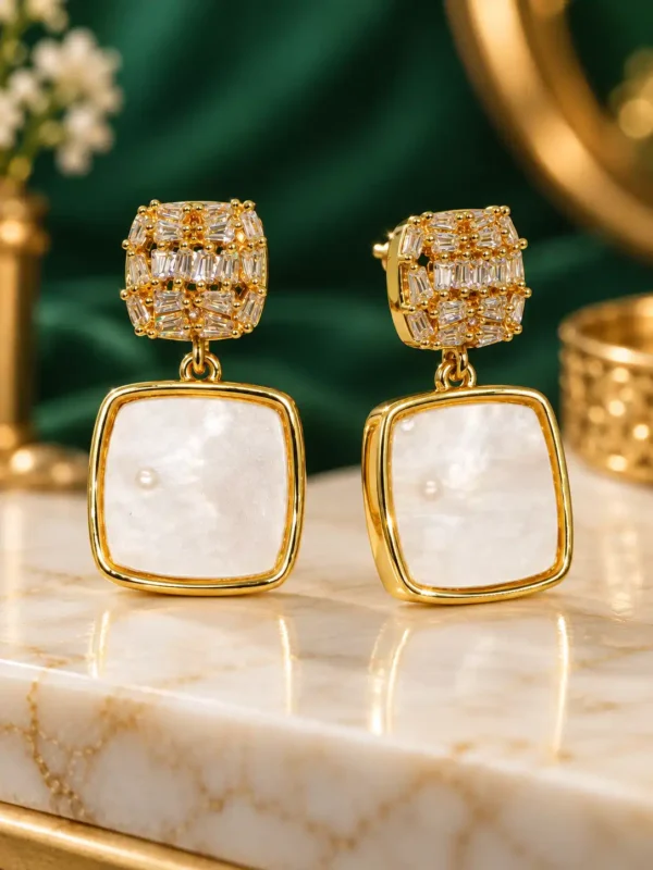 Aurelia gold pearl-effect drop earrings with crystal square studs close-up