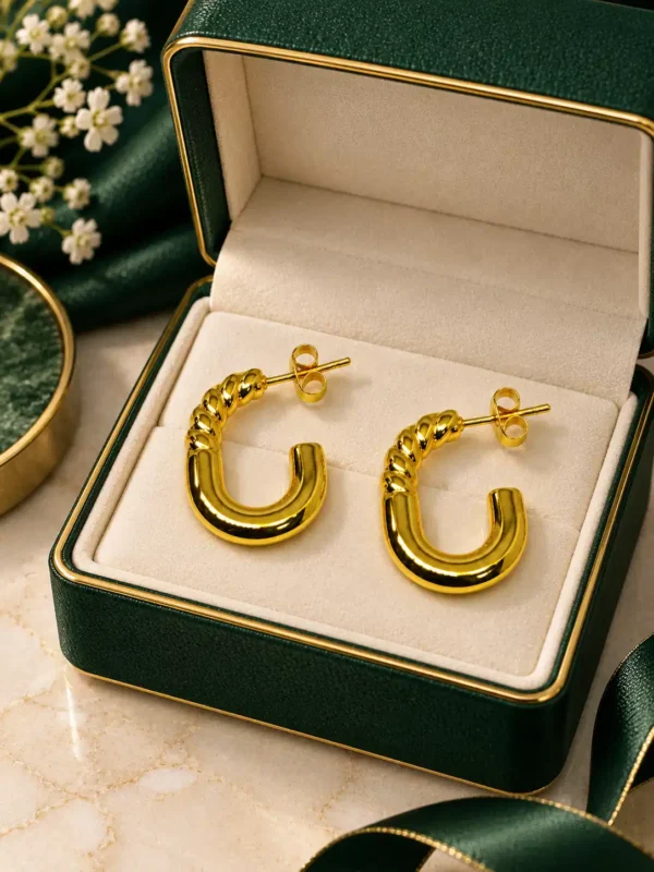 Anti-tarnish gold twist hoop earrings displayed in an open green jewellery box