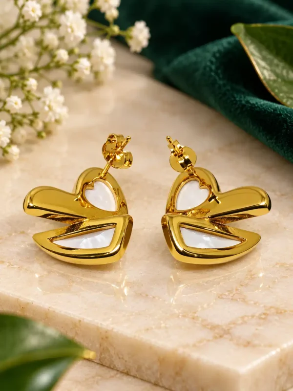 Front view of Ivory Sculpt anti-tarnish gold heart stud earrings with white mother-of-pearl accents