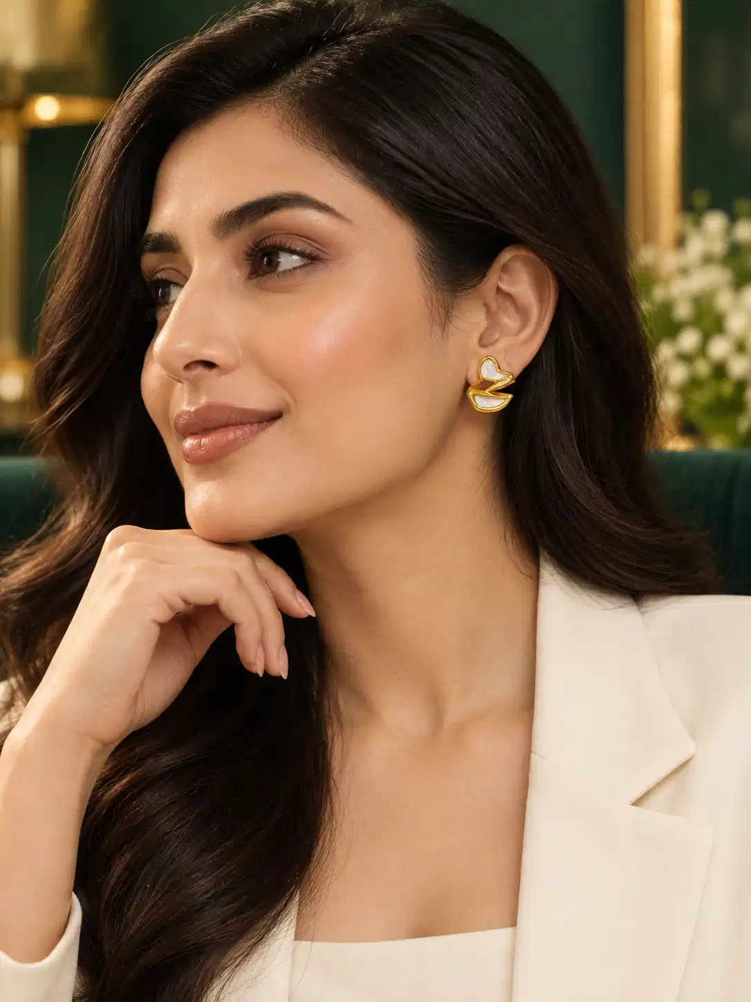 Woman wearing Ivory Sculpt anti-tarnish gold heart stud earrings with white mother-of-pearl accents