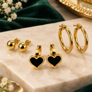 Three-pair gold-plated earring set with ball studs, black heart earrings and classic hoops