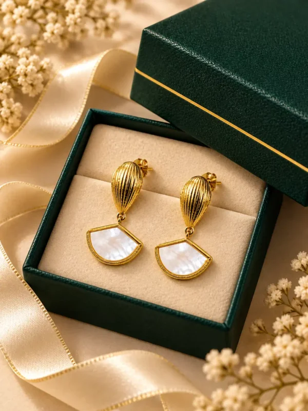 Aurelia gold and white shell fan drop earrings displayed in jewellery box