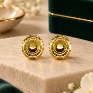 Aurelia anti-tarnish gold stud earrings with polished dome centre and textured oval border