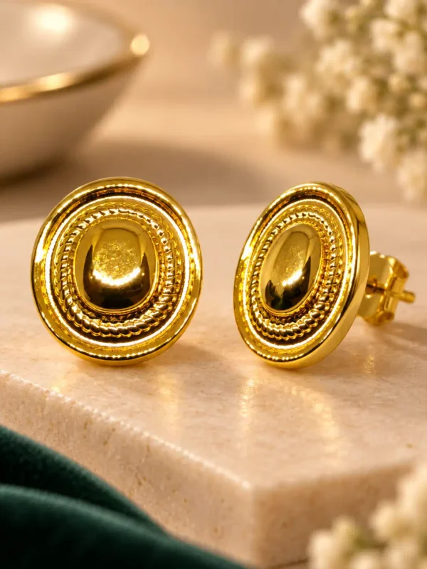 Close-up of Aurelia gold dome stud earrings showing concentric rope-textured detailing