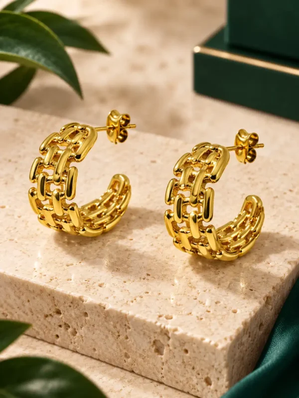 Pair of textured gold woven hoop earrings with interlocking link pattern and post backs