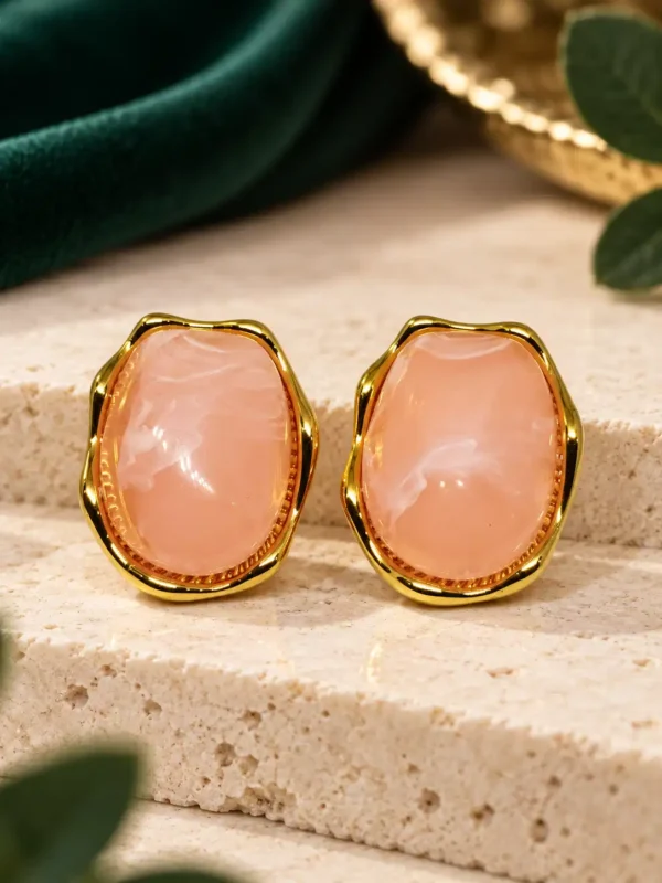 Pair of anti-tarnish gold-plated stud earrings with blush pink glossy centres
