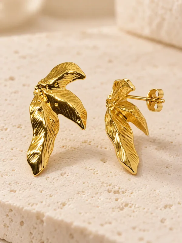 Aurelia gold wing stud earrings showing sculpted front and push-back post closure