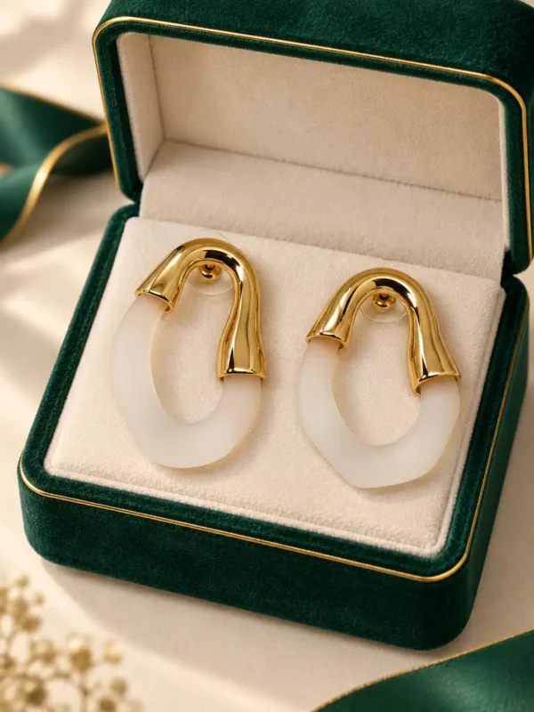 Elara gold and ivory hoop earrings displayed in green jewellery box