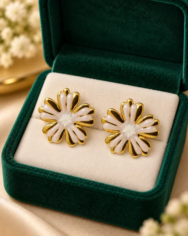 Aurelia Ivory Bloom white and gold floral stud earrings displayed in a dark green jewellery box